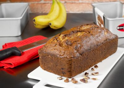 Banana Bread with bread knife, banana and bread pans in a bakery