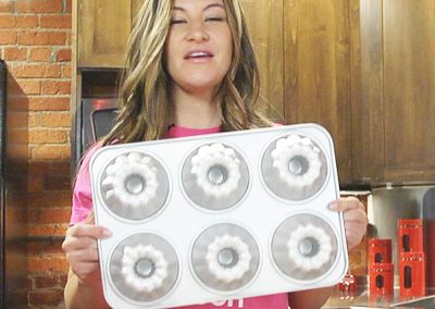 Miesha Tate with fluted mini muffin cupcake cake pan in a bakery