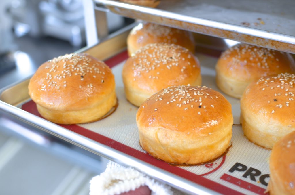 golden brown buns baked on a sheet pan