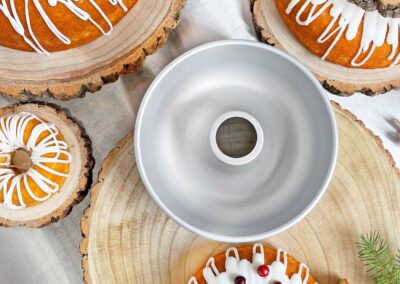 Ring mold pan with holiday cakes on wood rounds